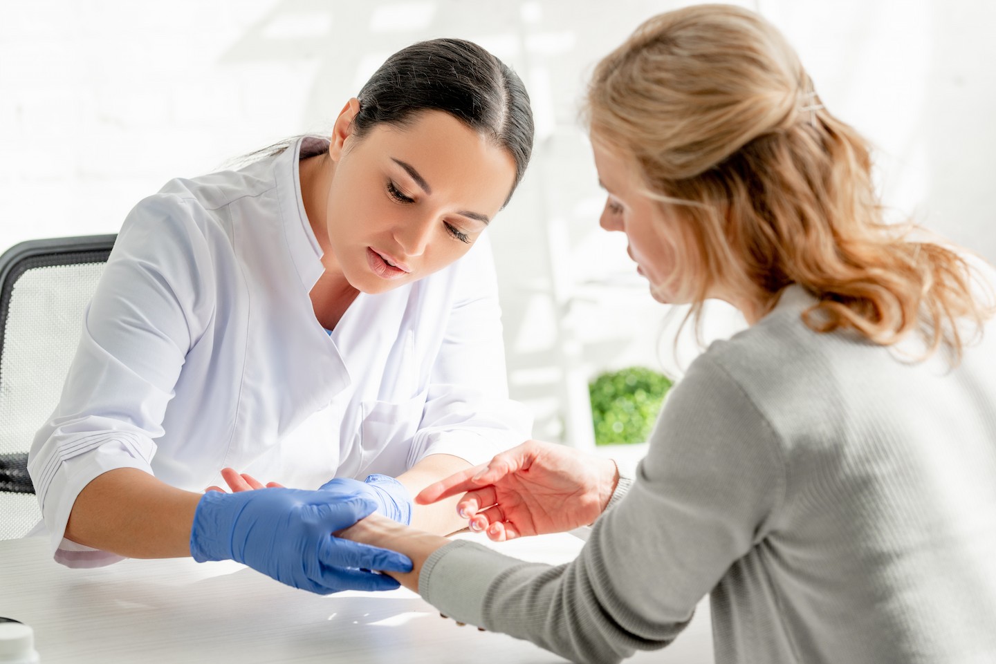 DermLegal doctor providing a dermatological consultation and skin examination.